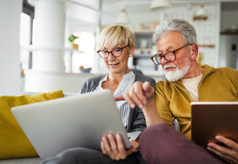 Happy romantic senior couple hugging and enjoying retirement at home