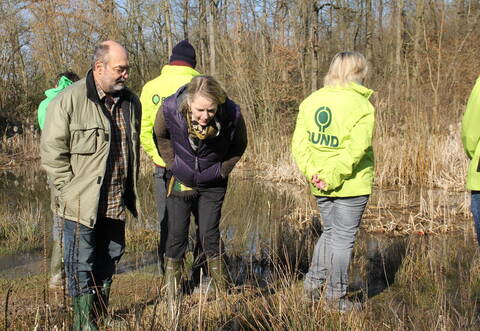 Kleine Maßnahme, große Wirkung. In Ötisheim zeigt ein eigens saniertes Gewässer, was im Amphibienschutz möglich ist. Thomas Köberle vom BUND Mühlacker (links) und die Ministerin Thekla Walker (Mitte) schauen ganz genau hin.