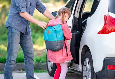 Dad Picks Up Little Daughter From School And Helps Her Get In Car