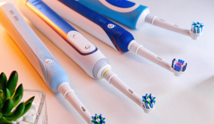 electric toothbrushes lie on the table in the bathroom