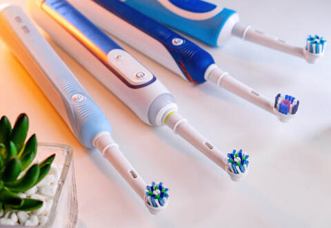 electric toothbrushes lie on the table in the bathroom