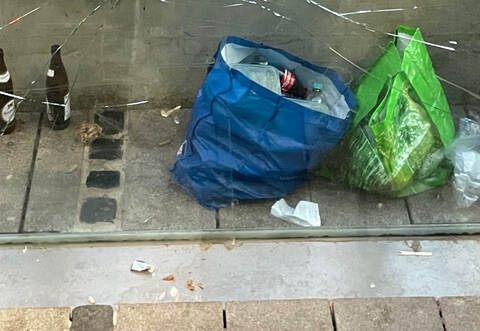 Bierflaschen hinter der Bank einer Bushaltestelle am Leopoldplatz in Pforzheim.