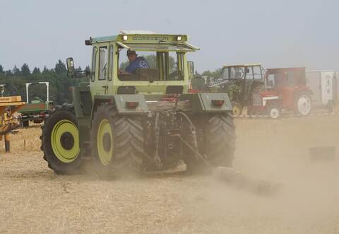 Bei einem Geschicklichkeitswettbewerb müssen die Teilnehmer mit ihrem Traktor einen Holzstamm durch einen Parcours ziehen. Es kommt auf Schnelligkeit und Fehlerfreiheit an.