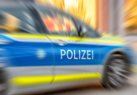 Motion blur of German police car with letters POLIZEI.