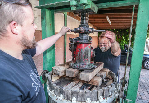 Rund eine Stunde lang pressen Conny Vielsack (rechts) und Tim Augenstein mit Muskelkraft und viel Geduld den Saft aus den Johannisbeeren. Beim Hanselfest will es Vielsack körperlich ruhiger angehen, sagt der Chef der Froschwaidbande mit einem Schmunzeln auf den Lippen.