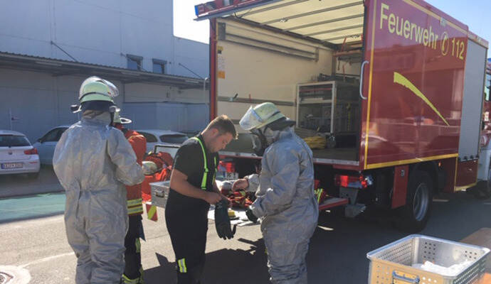 Nur mit Schutzanzügen näherten sich die Feuerwehrleute der Stelle, an der ein Transporter bei einer Königsbacher Firma Phosphorsäure verloren hatte.
