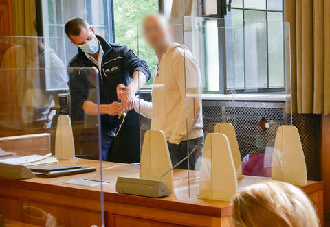 Einer der beiden Angeklagten (M) wird in einen Gerichtssaal im Landgericht Tübingen geführt. Den Angeklagten wird Freiheitsberaubung, Raub und Erpressung vorgeworfen. Sie sollen zwei Pflegekräfte eingesperrt haben, um zu fliehen.