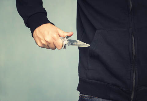 A maniac with a knife in his pocket. The murderer hides a small folding knife. Intimidation with a knife in the robbery. mafia