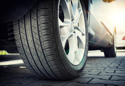 Car tire close up, parked car low angle shot