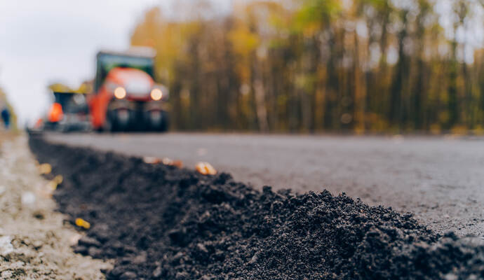 Close view on the new road construction site. Close-up asphalt at the road under construction. Asphalting