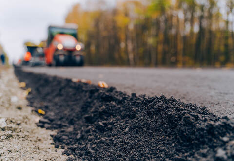 Close view on the new road construction site. Close-up asphalt at the road under construction. Asphalting