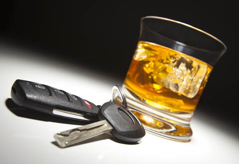 Alcoholic Drink and Car Keys Under Spot Light.
