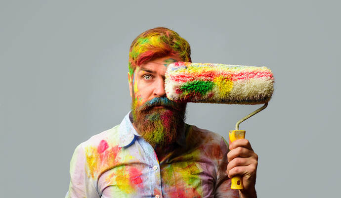Painter man. Professional painter, decorator. Repair, building concept. Room painting job. Handsome bearded worker with paint ro