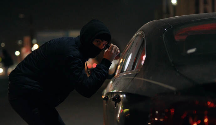 Auf schwarze Autos hatten es Unbekannte in Tiefenbronn und Friolzheim abgesehen. Robber man checking breaking entering alarm shines a flashlight in a car stealing at night crime male thief illegal theft stolen