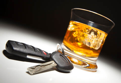 Alcoholic Drink and Car Keys Under Spot Light.
