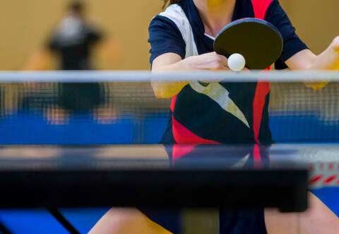 close up of a table tennis player returning