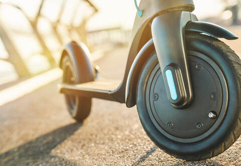 Close up of elecric scooter front view outdoor on city street