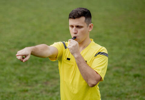 Referee indicates a violation of the rules. Concept of sport, rules violation, controversial issues, obstacles overcoming.