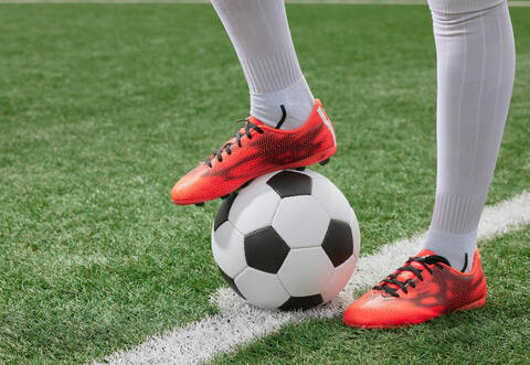 sports girl football player with a soccer ball on the soccer field, the concept of professional women's football