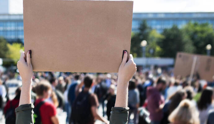Rear view of people with placards and posters on global strike for climate change.
