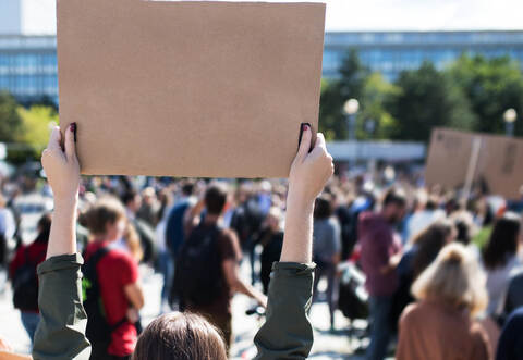 Rear view of people with placards and posters on global strike for climate change.
