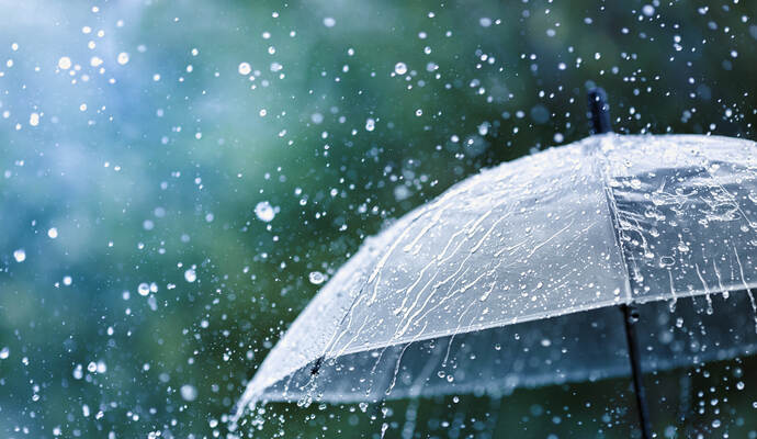 Drops of warm summer rain, falling on the asphalt