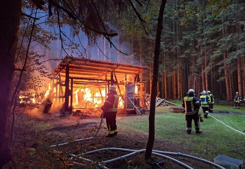Mit einer Riegelstellung schirmt die Feuerwehr den Wald vor den Flammen ab.