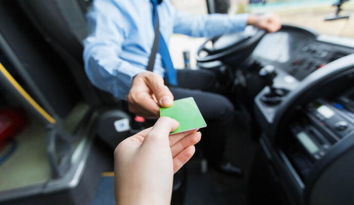 bus driver taking ticket or card from passenger